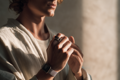 A sophisticated adult wearing discreet health technology in a calm modern setting, representing how smartwatches, smart rings, and continuous personal data are becoming part of preventive health.